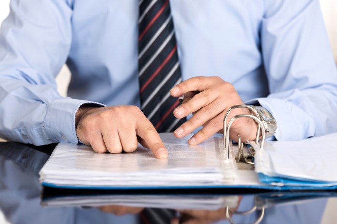Businessman reading the contract before signing it